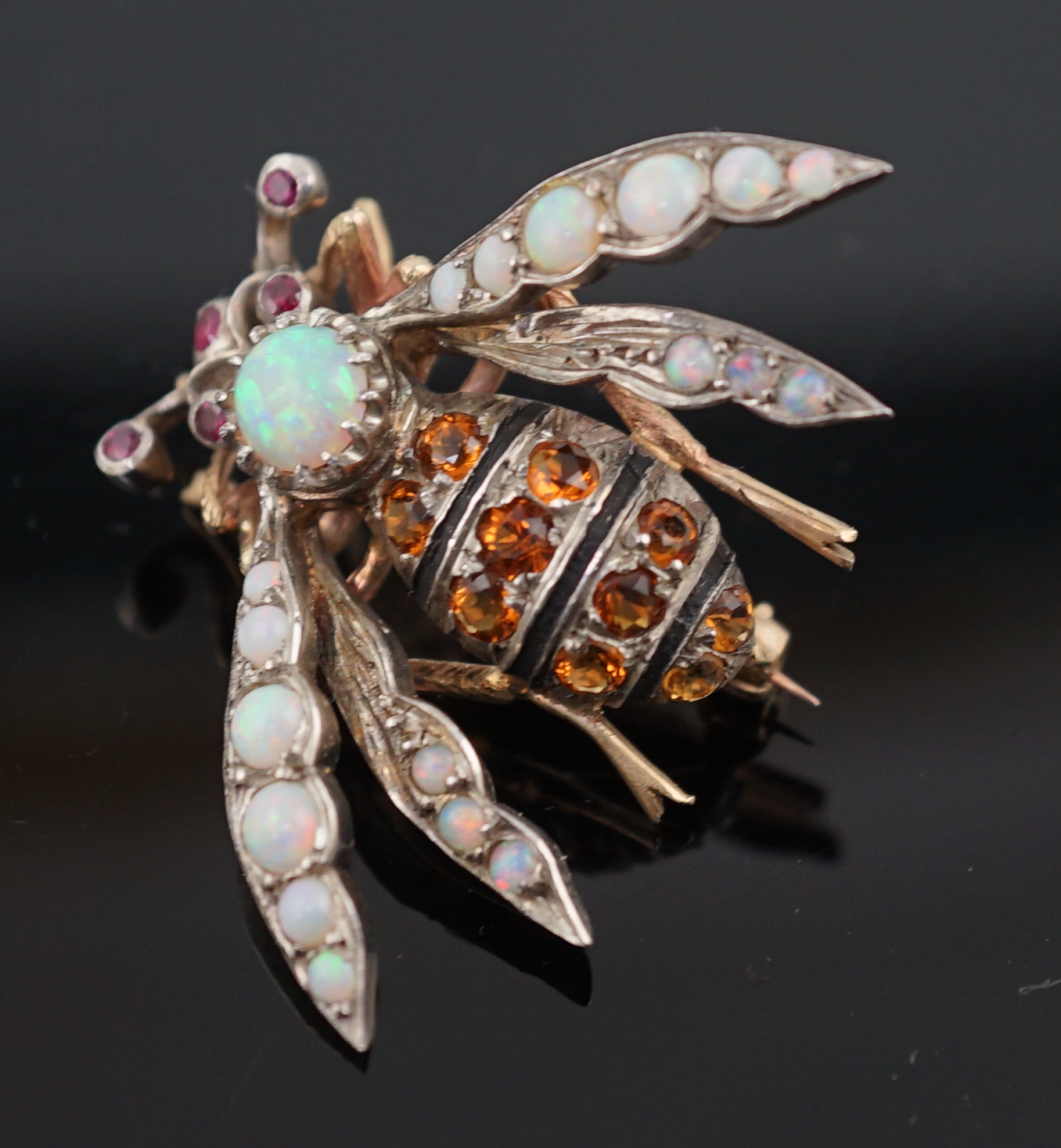A late Victorian gold and silver, white opal, ruby and citrine? cluster set bug brooch